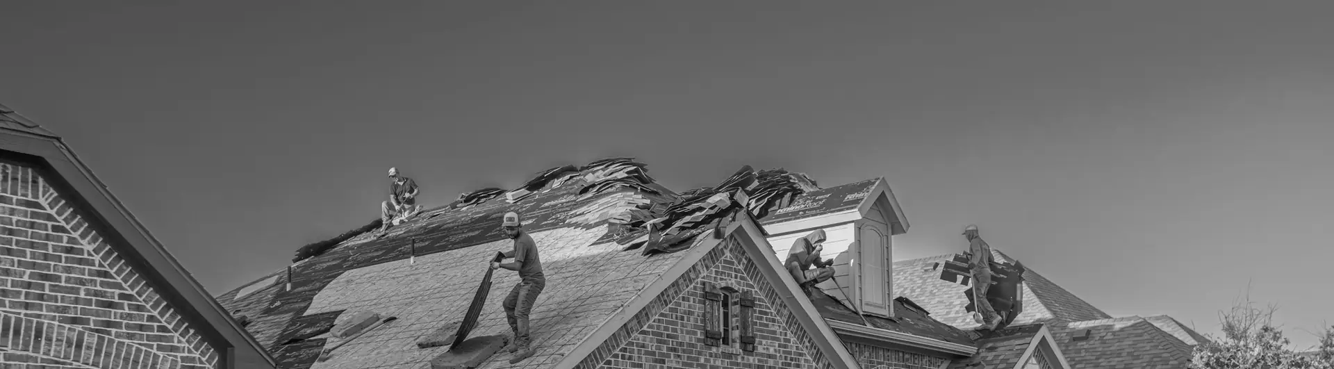 Crew re-roofing a house