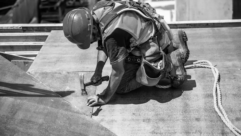 Roofer laying new sheathing