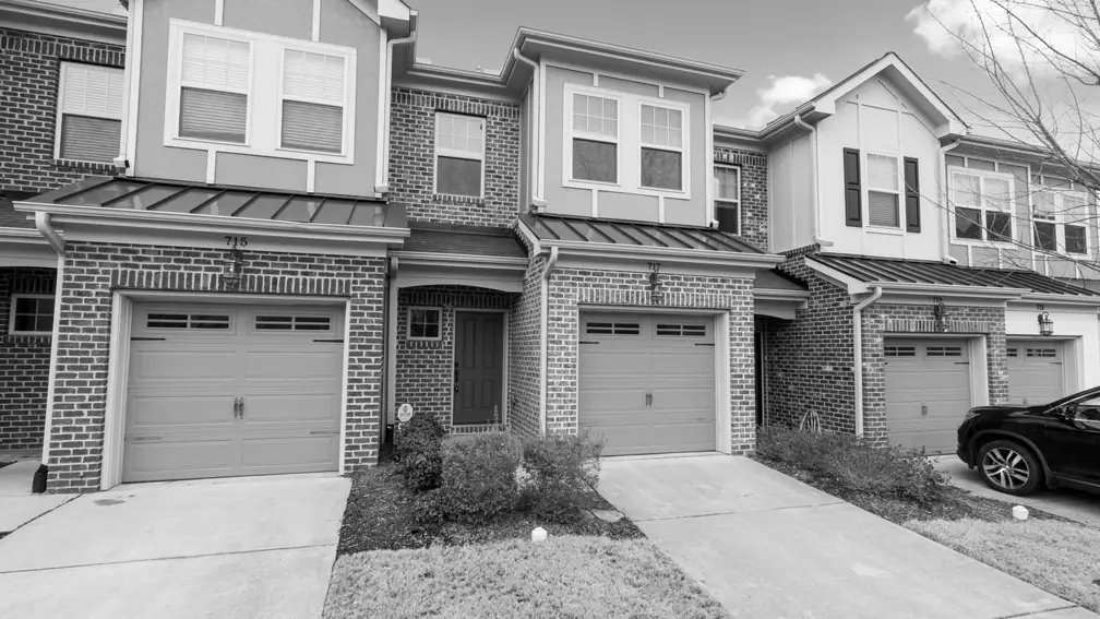Row of brick townhomes with shingle roofs